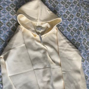 Hoodie in a light yellow/ cream color.